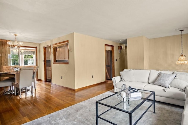 12 Cassidy Dr, Woburn, MA 01801 - living area with a chandelier, wood finished floors, and baseboards