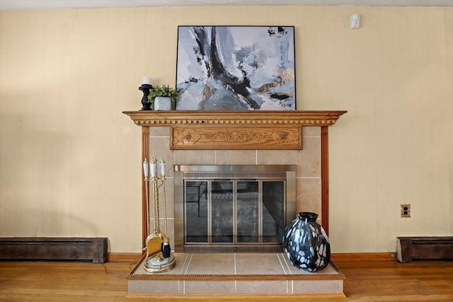 12 Cassidy Dr, Woburn, MA 01801 - detailed view of wood finished floors, a baseboard heating unit, a fireplace, and baseboards