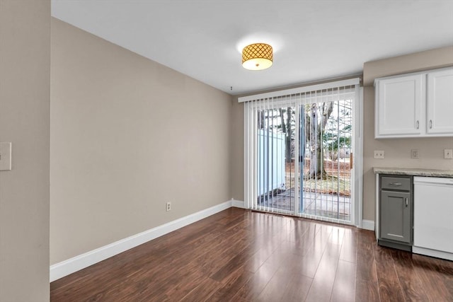 unfurnished dining area featuring dark hardwood / wood-style flooring