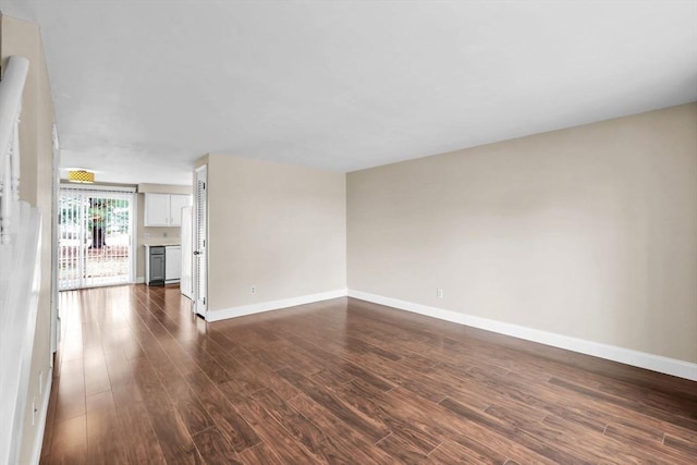 empty room with dark wood-type flooring