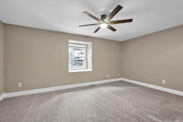 carpeted spare room with ceiling fan