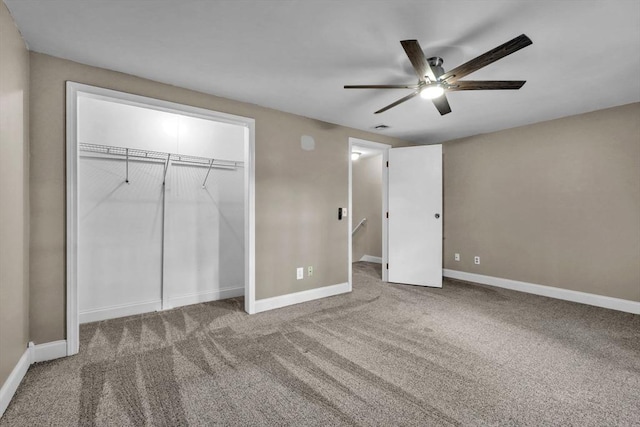 unfurnished bedroom with carpet floors, a closet, and ceiling fan