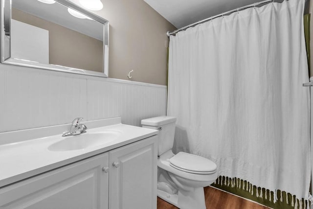 bathroom featuring hardwood / wood-style flooring, vanity, toilet, and walk in shower