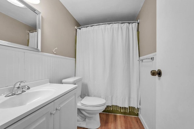 bathroom featuring walk in shower, hardwood / wood-style floors, vanity, and toilet