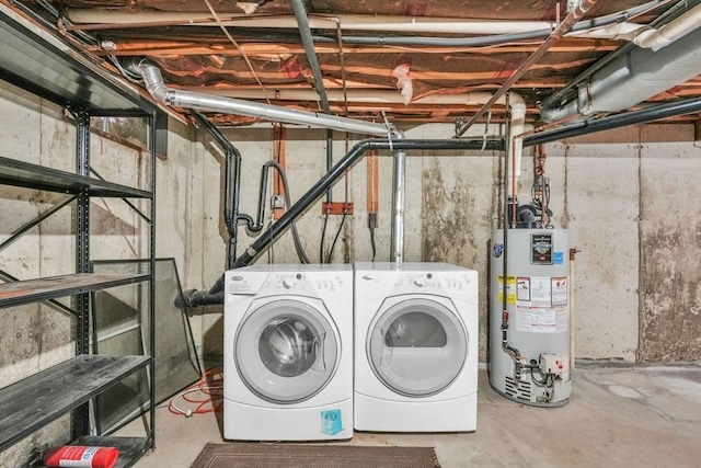 laundry room featuring washing machine and dryer and water heater