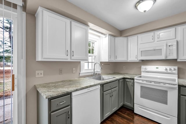 kitchen featuring gray cabinetry, sink, and white appliances