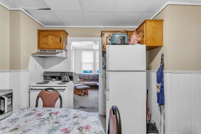 kitchen featuring a paneled ceiling and white appliances