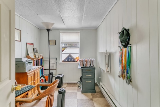 misc room featuring wood walls and a paneled ceiling