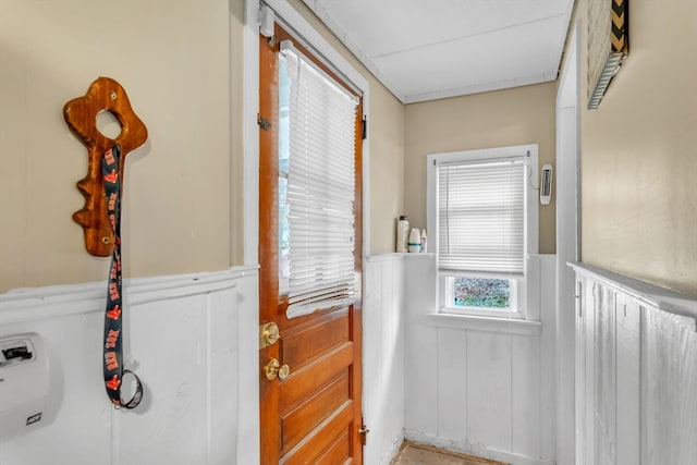 entryway featuring wood walls