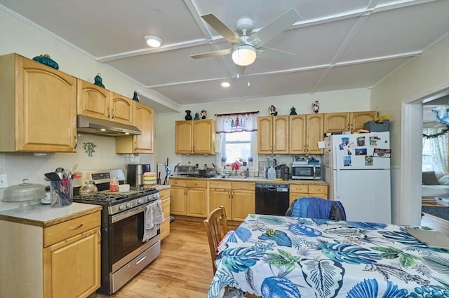 kitchen with light wood-type flooring, backsplash, ceiling fan, under cabinet range hood, and appliances with stainless steel finishes