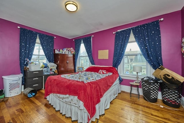 bedroom featuring wood-type flooring and baseboards