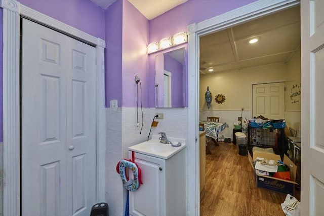 bathroom featuring wainscoting, vanity, and wood finished floors