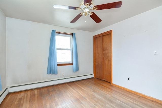 empty room with light wood-type flooring, baseboard heating, and ceiling fan