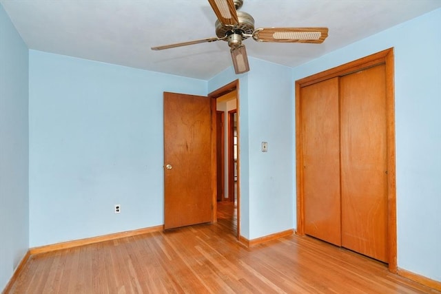 unfurnished bedroom with light hardwood / wood-style flooring, a closet, and ceiling fan