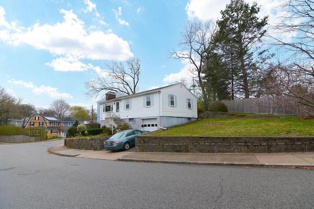 view of front of property with a garage and a front lawn