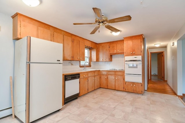 kitchen featuring ceiling fan, sink, a baseboard heating unit, white appliances, and decorative backsplash