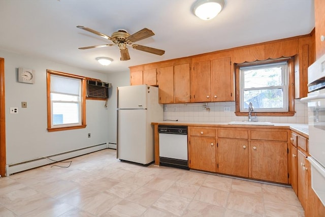 kitchen featuring white appliances, an AC wall unit, sink, ceiling fan, and baseboard heating