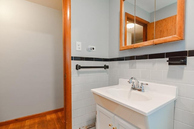 bathroom featuring vanity and tile walls