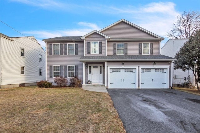 view of front of home featuring a garage and a front lawn