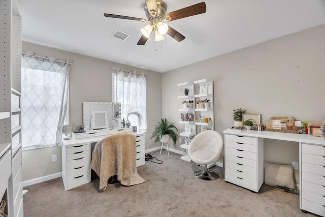 carpeted home office with ceiling fan