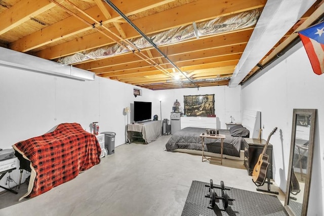 bedroom featuring concrete flooring