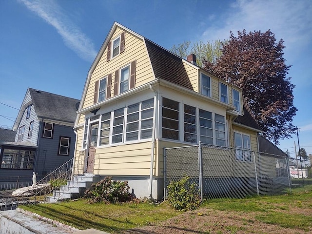 1123 S Broadway, East Providence, RI 02914 - view of front of home with a gambrel roof, a chimney, and fence
