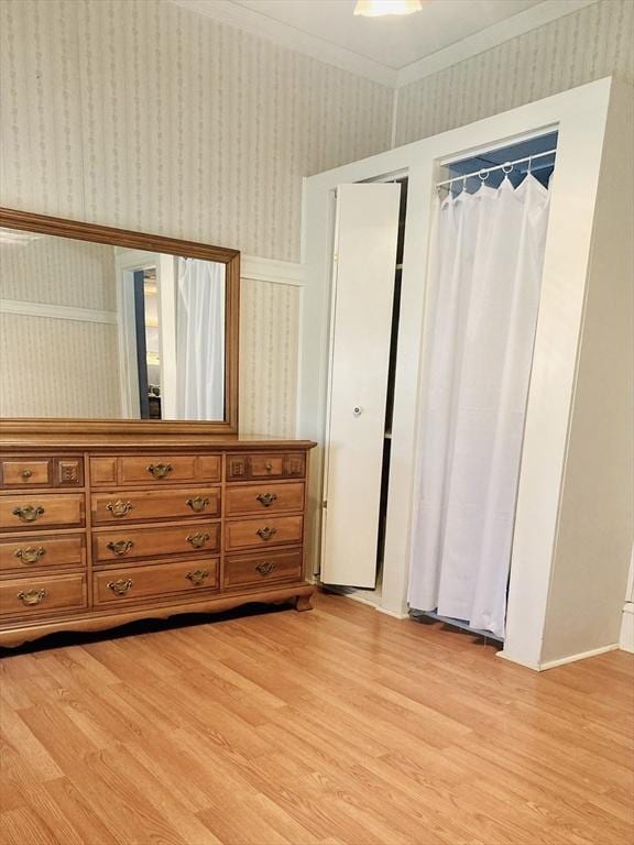 1123 S Broadway, East Providence, RI 02914 - bedroom featuring wallpapered walls, light wood-style flooring, and a closet