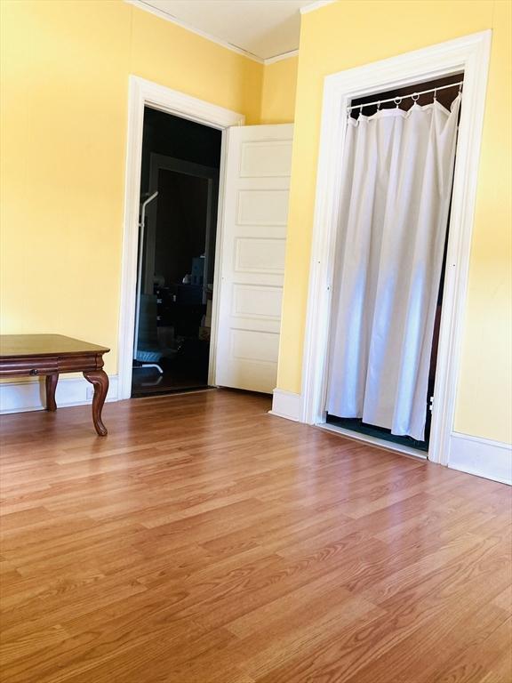 1123 S Broadway, East Providence, RI 02914 - spare room with ornamental molding and wood finished floors