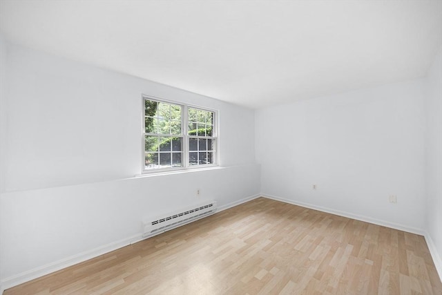 118 Parker St Unit 16, Acton, MA 01720 - empty room featuring a baseboard heating unit, light wood-style floors, and baseboards