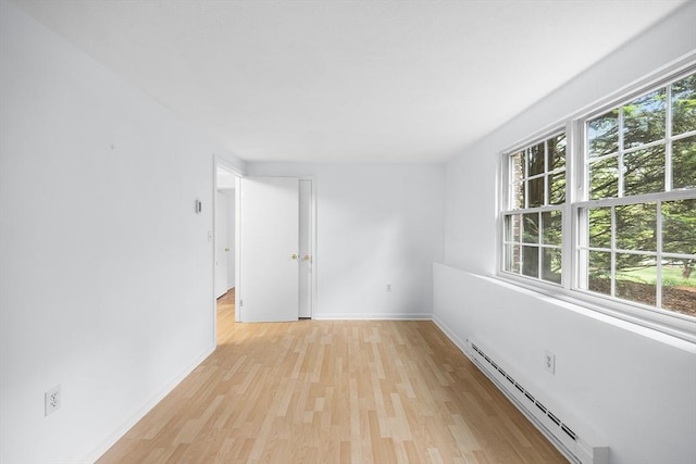118 Parker St Unit 16, Acton, MA 01720 - empty room featuring a baseboard radiator, light wood-style floors, and baseboards