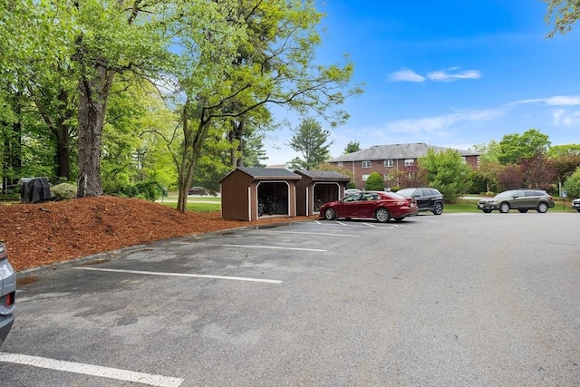 118 Parker St Unit 16, Acton, MA 01720 - uncovered parking lot featuring a storage unit