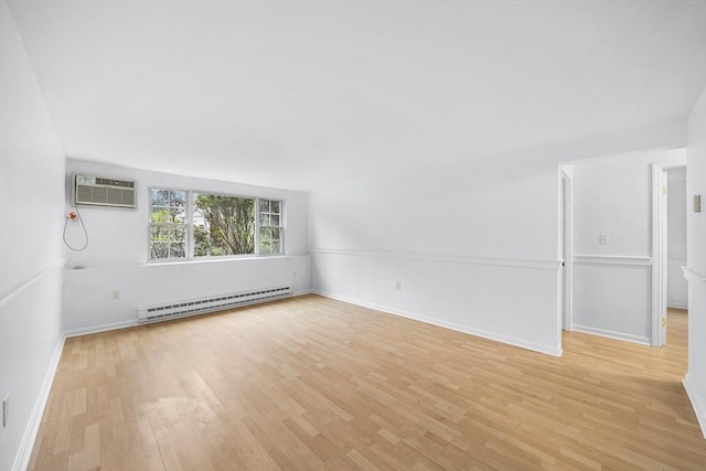 118 Parker St Unit 16, Acton, MA 01720 - spare room with a baseboard heating unit, an AC wall unit, light wood-type flooring, and baseboards
