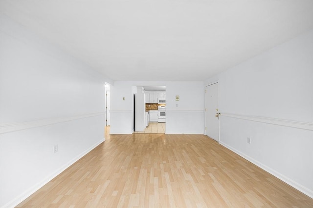 118 Parker St Unit 16, Acton, MA 01720 - unfurnished living room featuring light wood-type flooring and baseboards