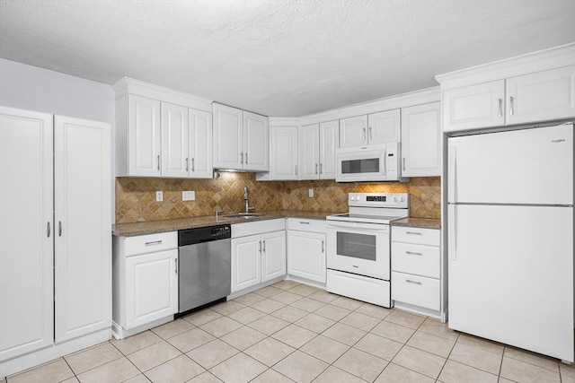 118 Parker St Unit 16, Acton, MA 01720 - kitchen featuring white appliances, white cabinetry, backsplash, light tile patterned flooring, and a textured ceiling