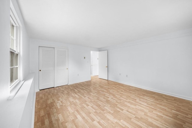 118 Parker St Unit 16, Acton, MA 01720 - unfurnished bedroom with light wood-style flooring, a closet, and baseboards