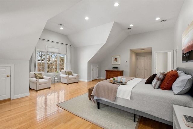 bedroom featuring light wood-style flooring, visible vents, vaulted ceiling, and recessed lighting