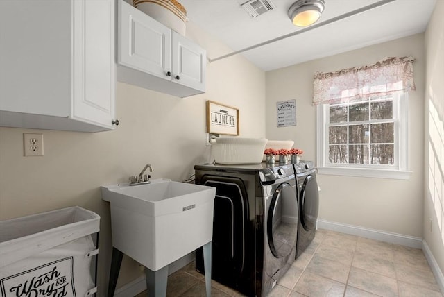 laundry area featuring cabinet space, baseboards, visible vents, washer and dryer, and a sink