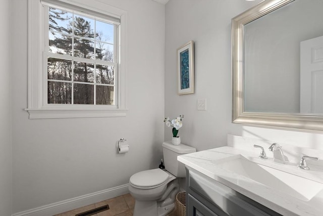 half bathroom featuring visible vents, baseboards, toilet, tile patterned flooring, and vanity