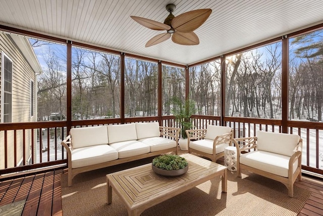 sunroom / solarium featuring ceiling fan