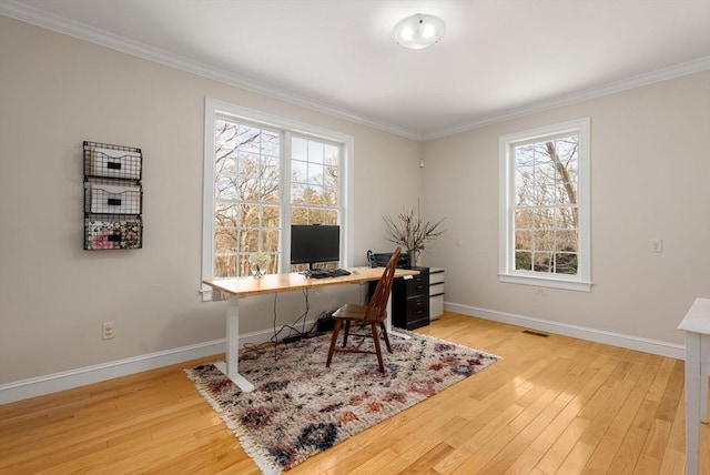 office with hardwood / wood-style flooring, plenty of natural light, and visible vents