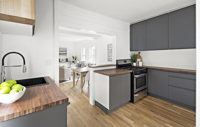 17 Bow Street Pl Unit 2, Somerville, MA 02143 - kitchen with wooden counters, stainless steel gas stove, a sink, light wood-type flooring, and gray cabinetry