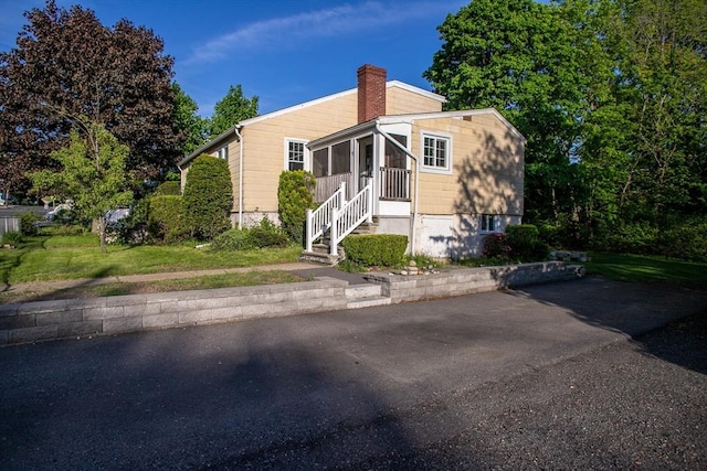 42 Giasson St, Hudson, MA 01749 - view of front of property featuring a sunroom and a chimney