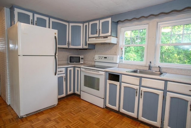 42 Giasson St, Hudson, MA 01749 - kitchen featuring white appliances, under cabinet range hood, a sink, light countertops, and decorative backsplash