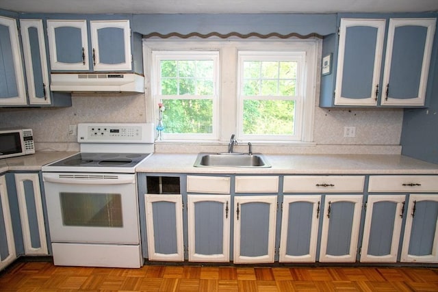 42 Giasson St, Hudson, MA 01749 - kitchen with white appliances, under cabinet range hood, a sink, light countertops, and tasteful backsplash