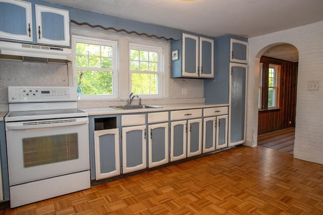 42 Giasson St, Hudson, MA 01749 - kitchen with white electric range, under cabinet range hood, light countertops, arched walkways, and a sink