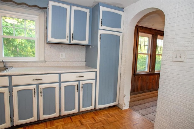 42 Giasson St, Hudson, MA 01749 - kitchen featuring light countertops, arched walkways, and a sink