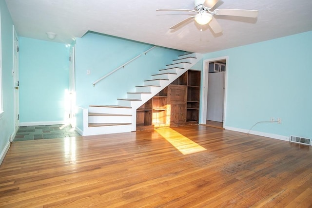 42 Giasson St, Hudson, MA 01749 - unfurnished living room with stairway, ceiling fan, wood finished floors, and baseboards