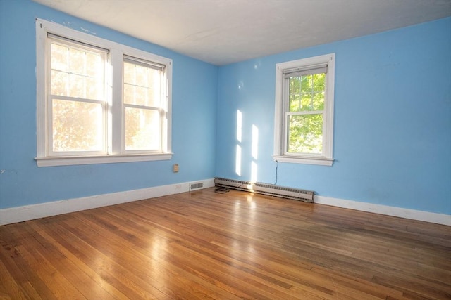 42 Giasson St, Hudson, MA 01749 - spare room featuring a baseboard radiator, wood finished floors, and baseboards