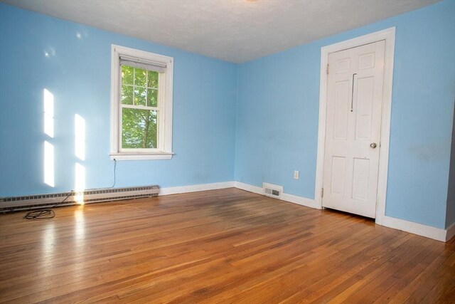 42 Giasson St, Hudson, MA 01749 - unfurnished room featuring baseboard heating, hardwood / wood-style flooring, and baseboards