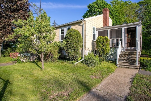 42 Giasson St, Hudson, MA 01749 - view of front of property featuring a chimney and a front lawn
